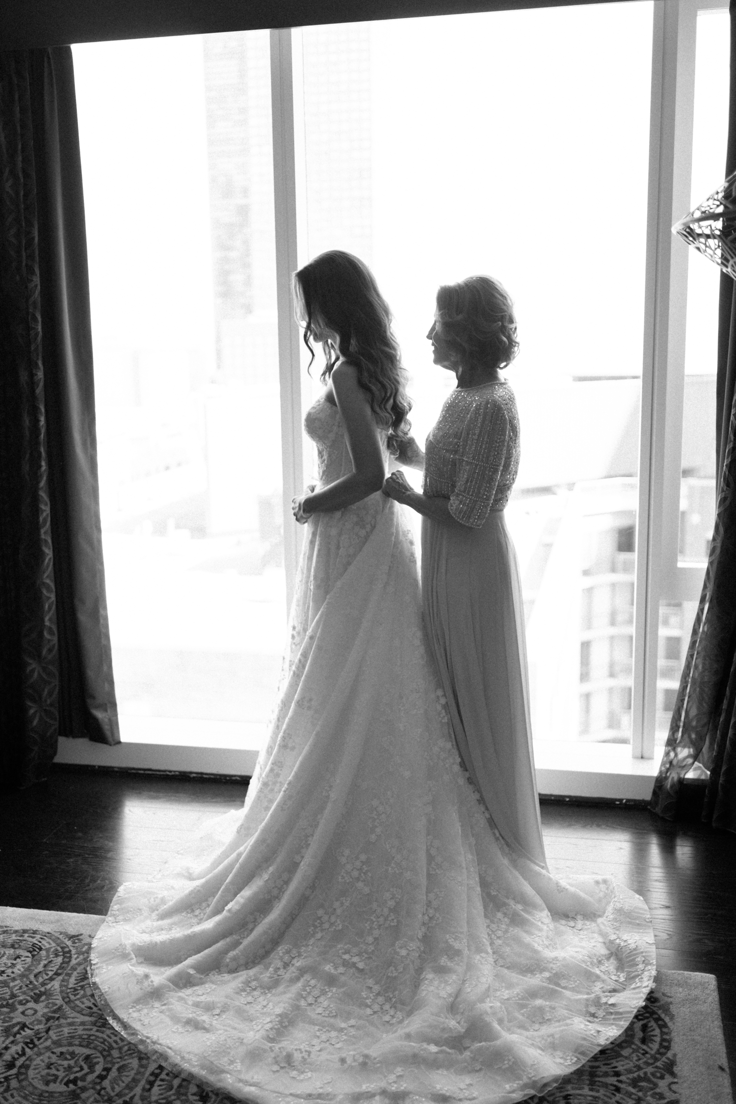 Bridal dress zipping at Revel motor row wedding, photography by Allison Francois