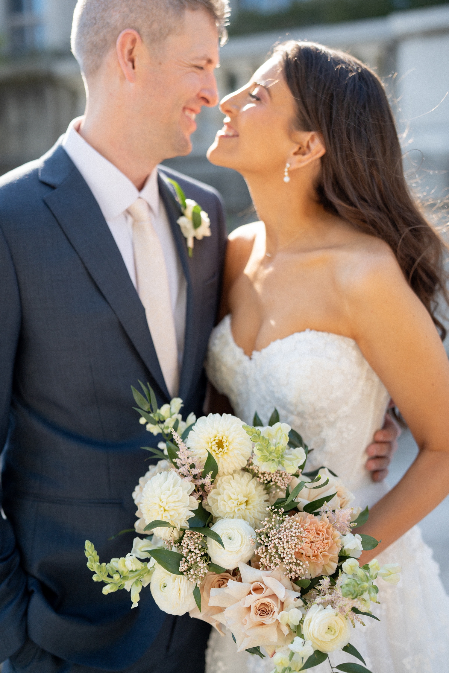 Bride and groom smiling at each other at Revel motor row weddings, photography by Allison Francois