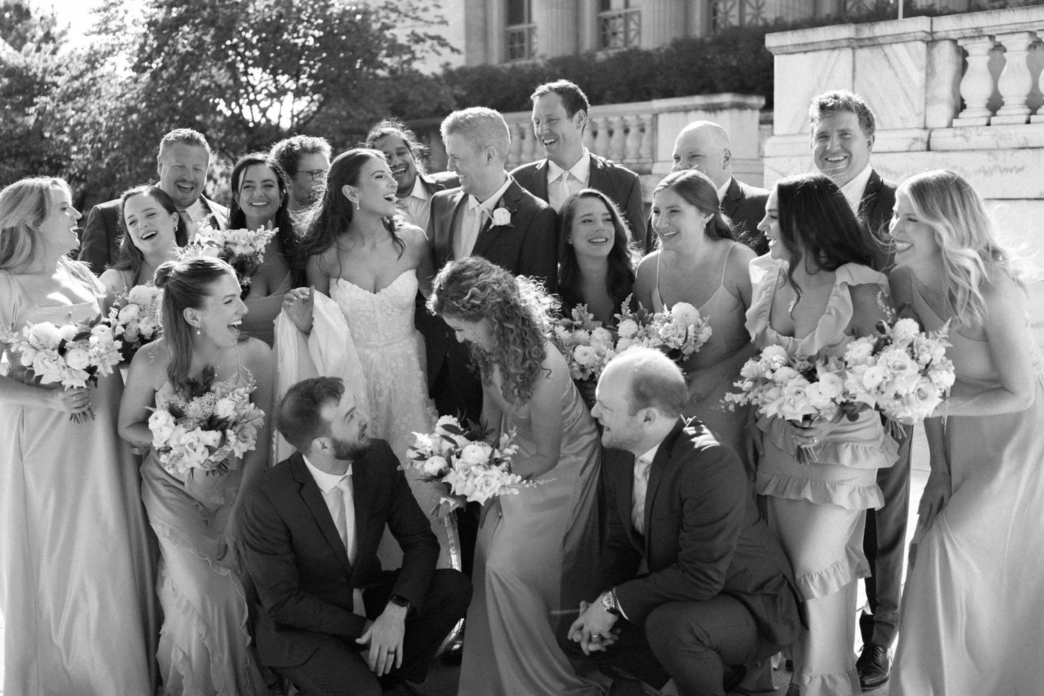 Bridal party embracing at Revel motor row weddings, photography by Allison Francois