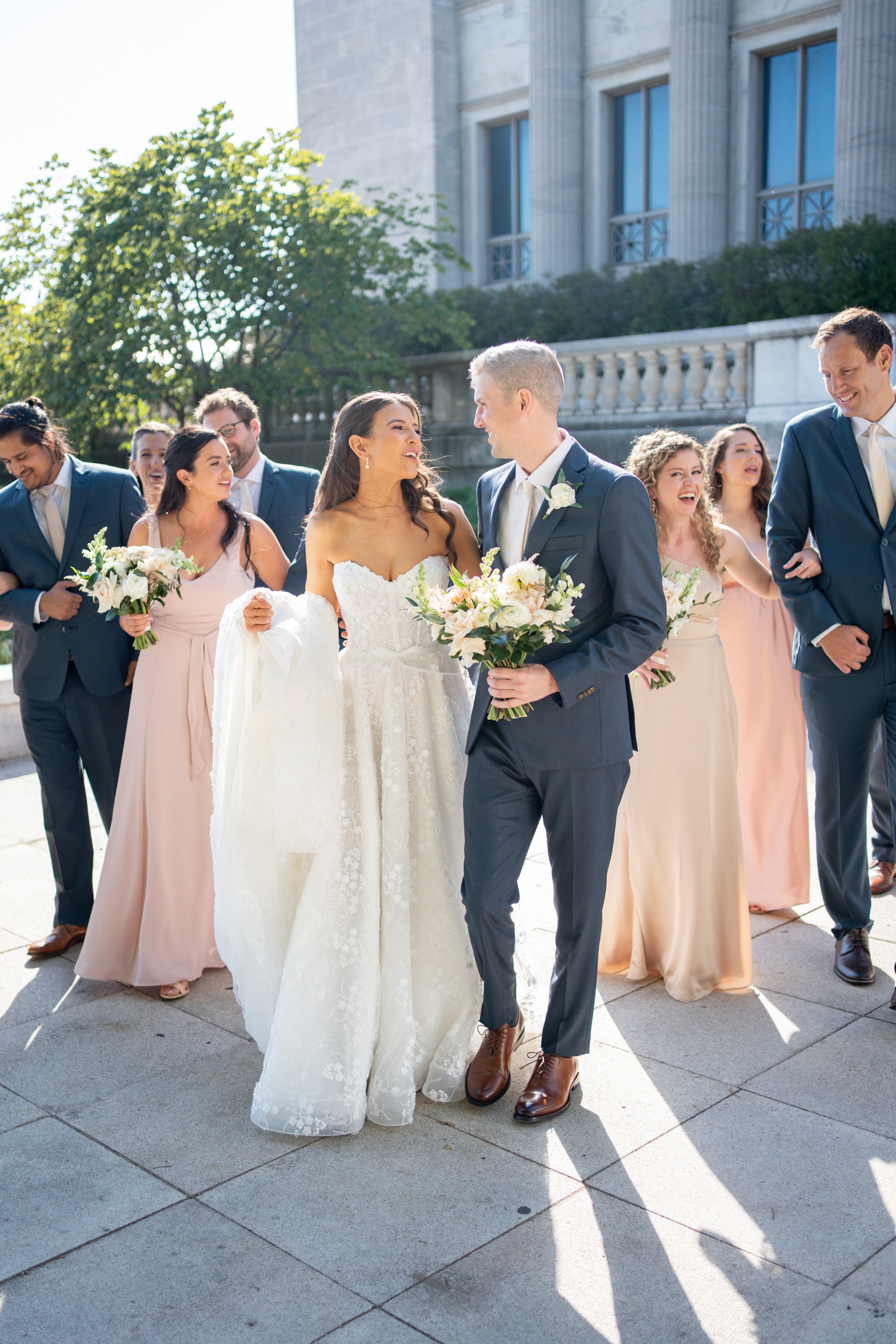 Bridal party smiling and laughing at Revel motor row weddings, photography by Allison Francois