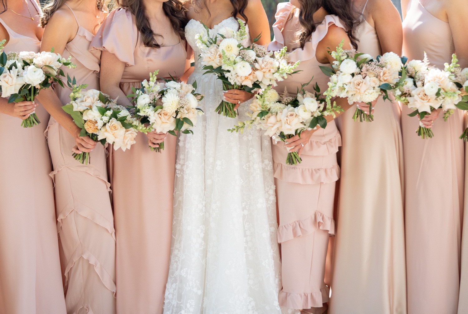 Bridesmaids holding bouquet at Revel motor row, photography by Allison Francois
