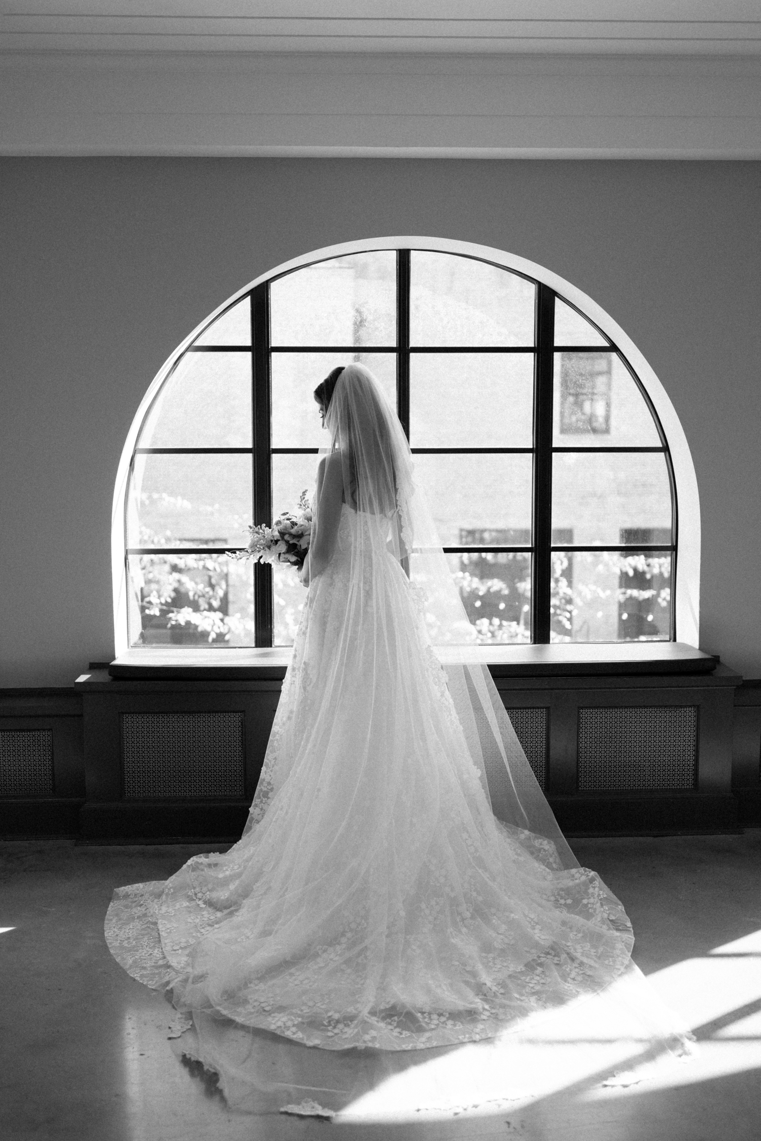 Bride in front of window at revel motor row chicago wedding