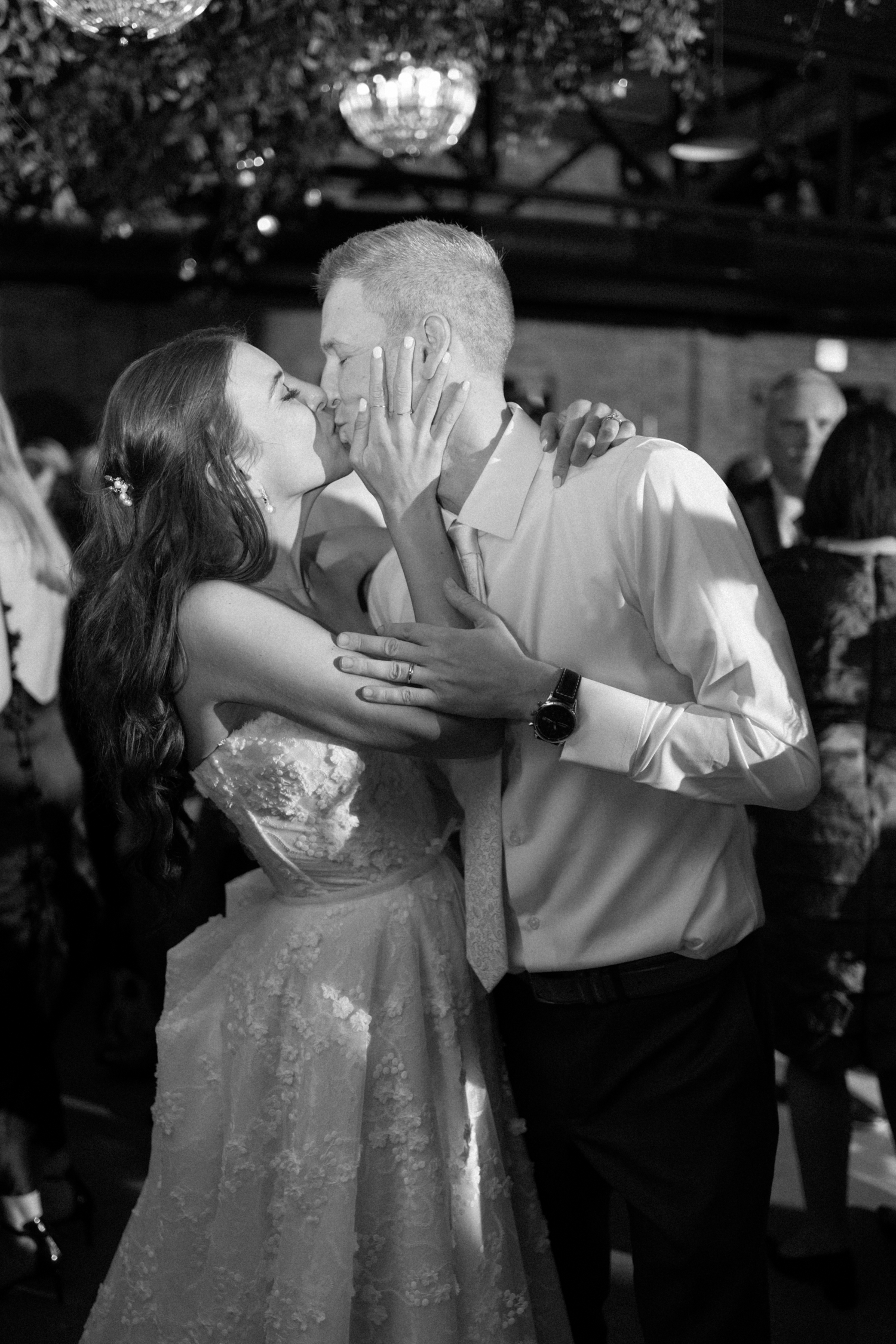 Bride and groom kissing at Revel Motor Row wedding by Chicago Wedding Photographer Allison Francois