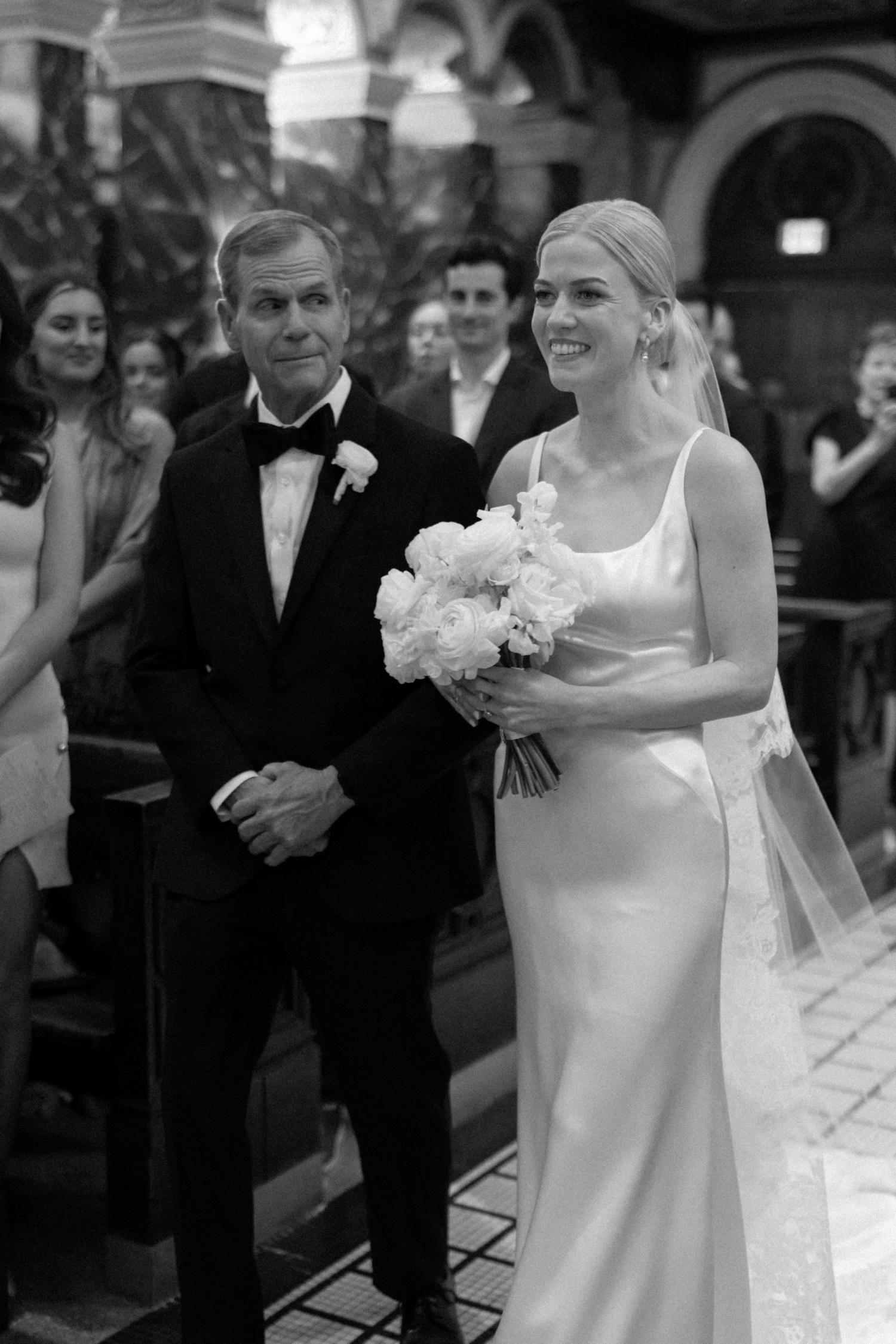 bride and father walking down wedding aisle