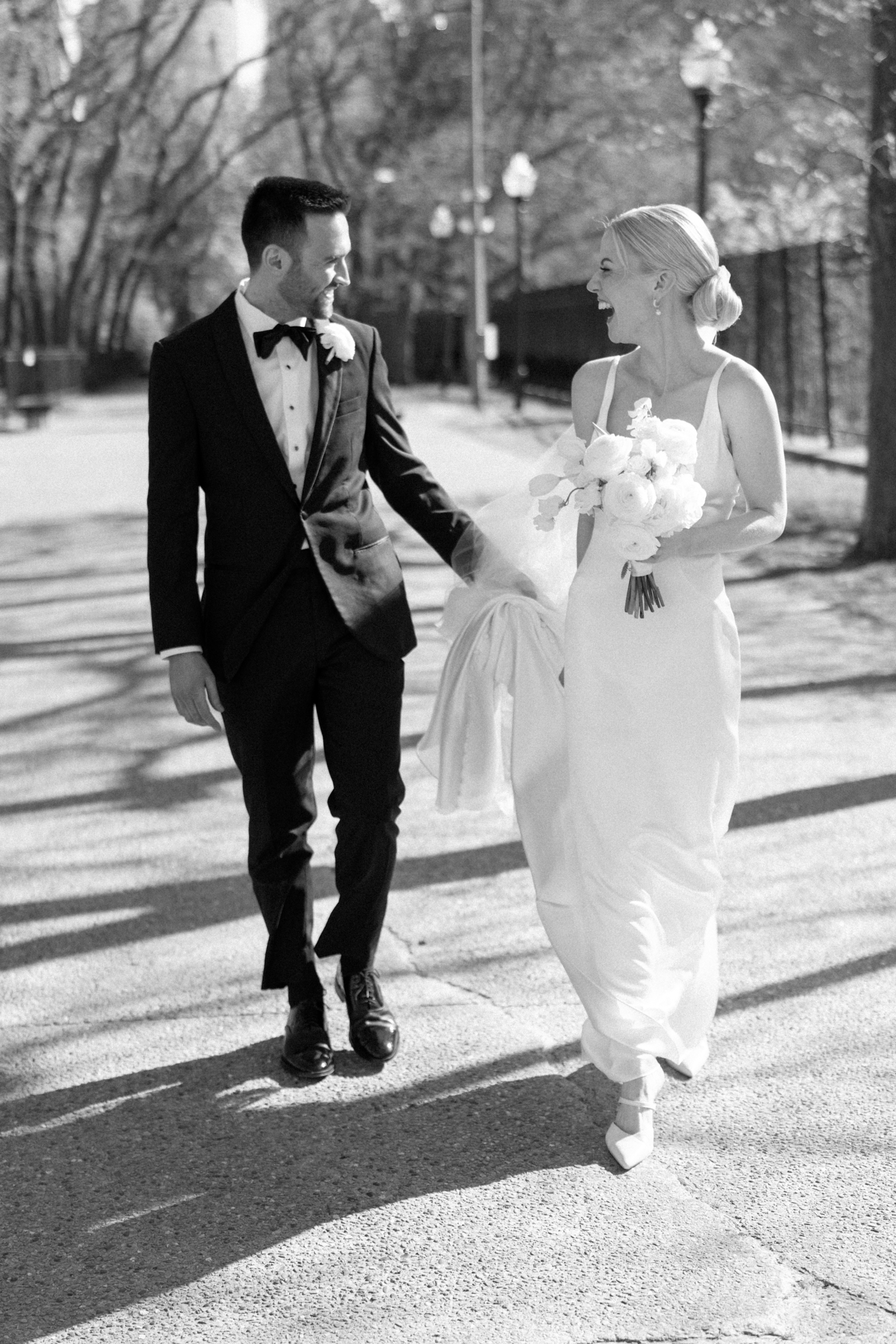 bride and groom walking and laughing at intercontinental chicago magnificent mile wedding