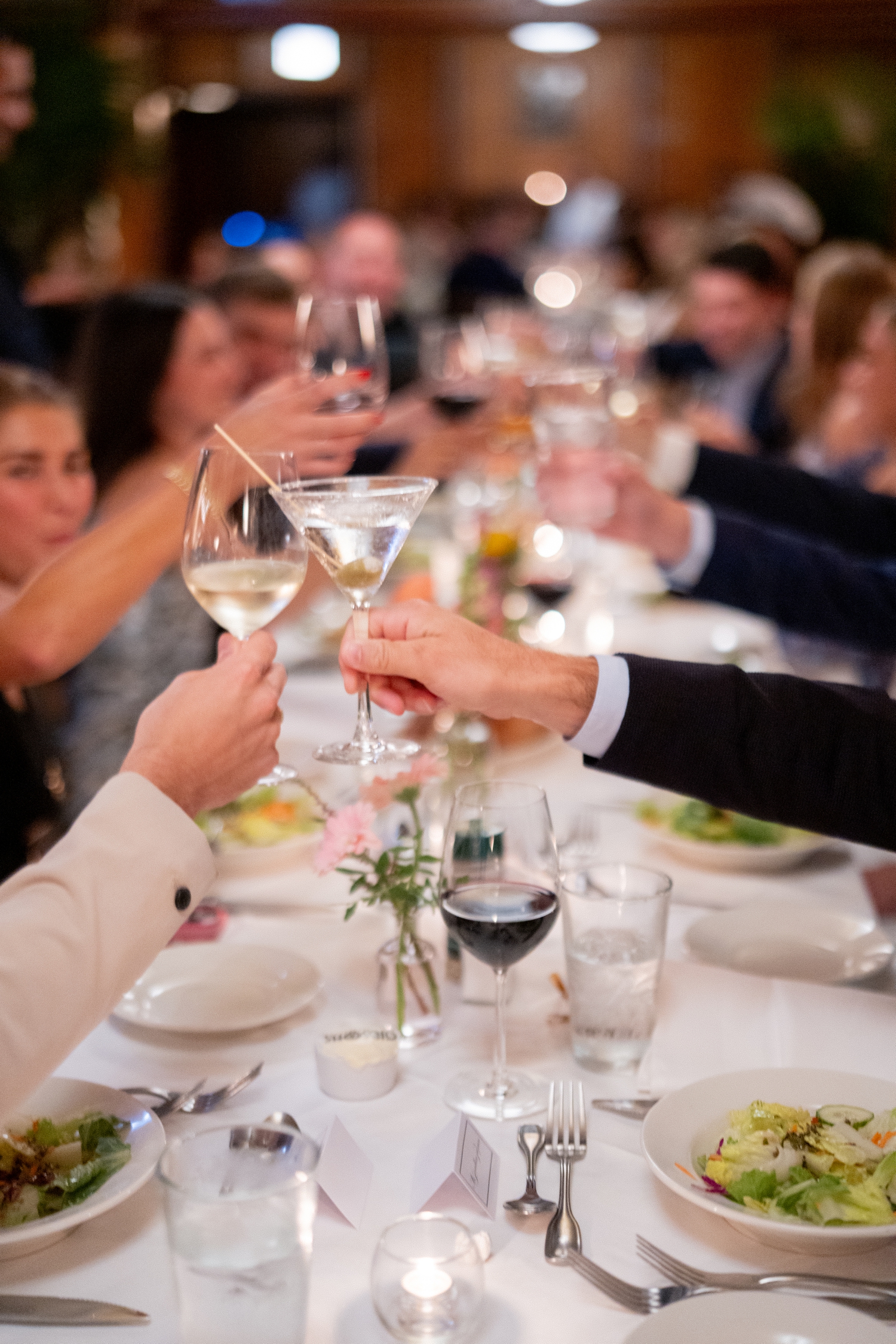 Bride and groom cheers at the wedding reception table at one of the chicago history museum weddings​ photographed by Allison Francois