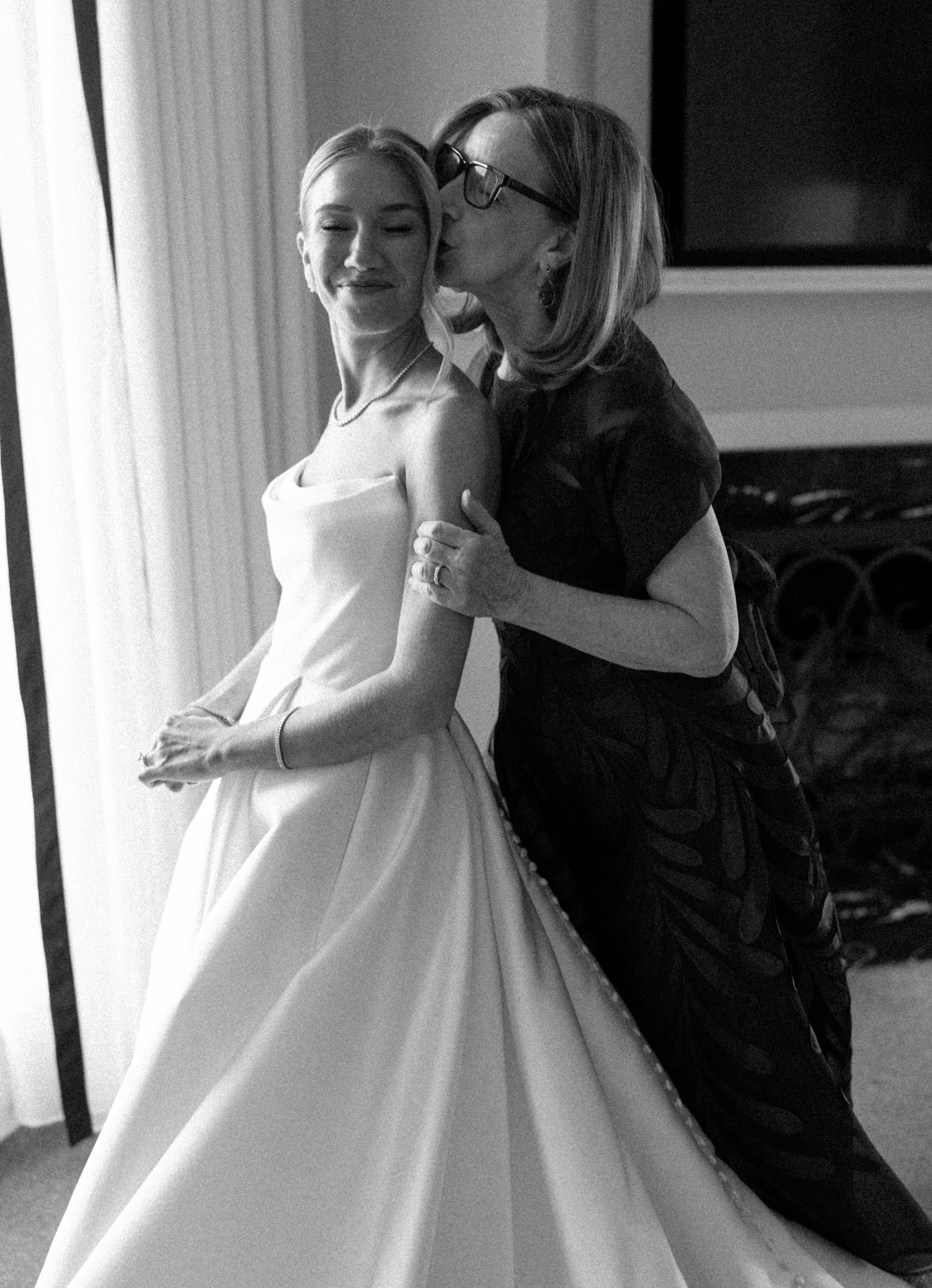 Bride's mom kissing bride at the chicago history museum wedding venue​

