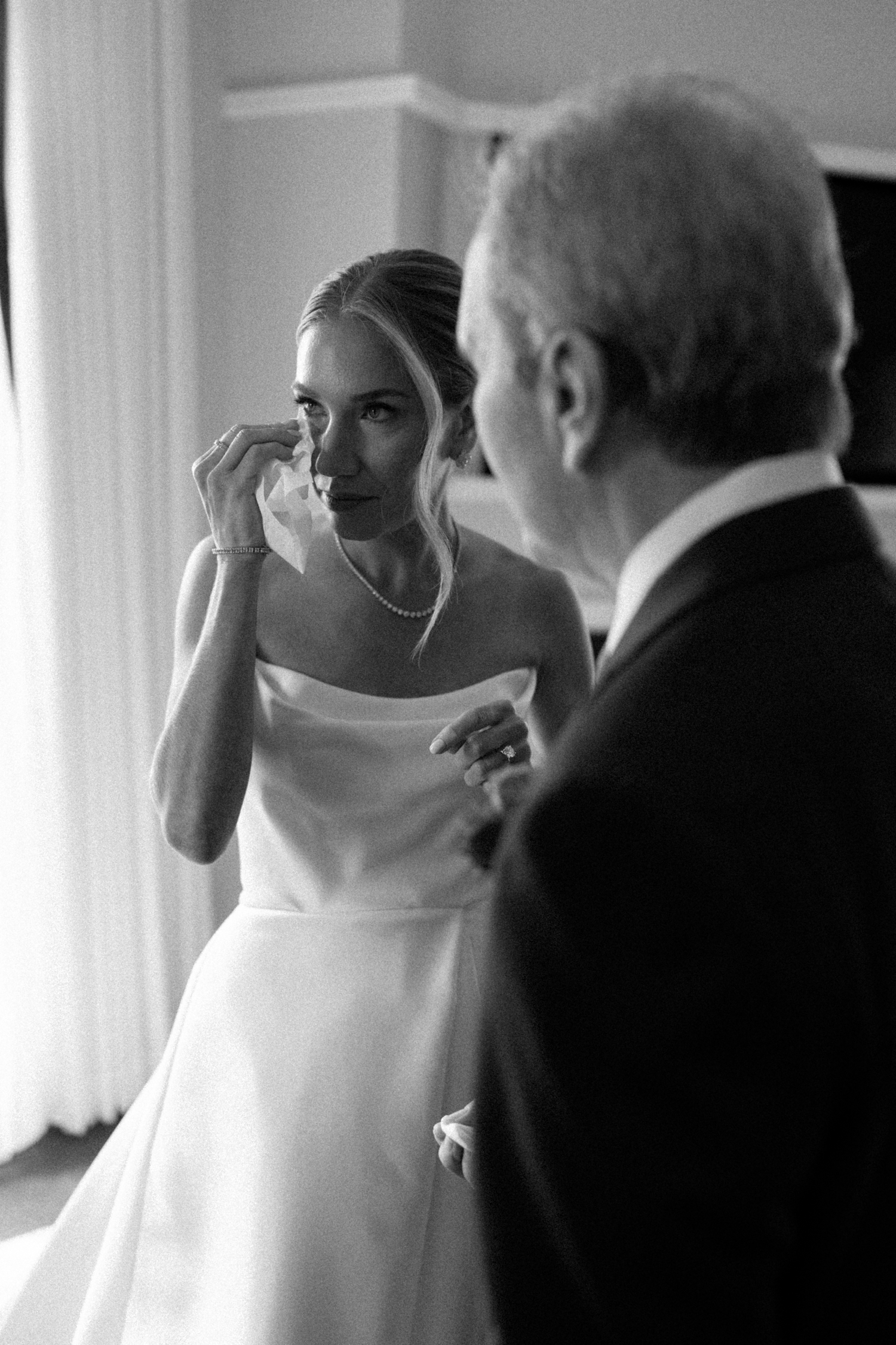 Bride wiping tears from her eyes at the chicago history museum wedding venue​

